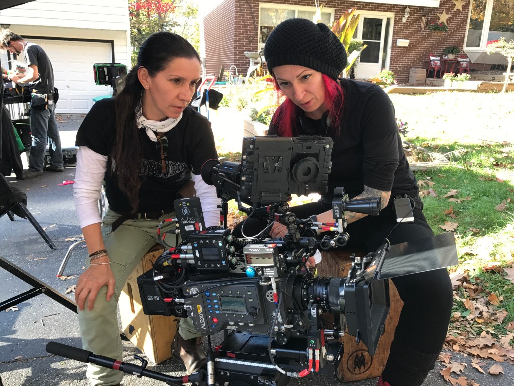 Jovanka Vuckovic and colleague looking at the screen of a production film camera